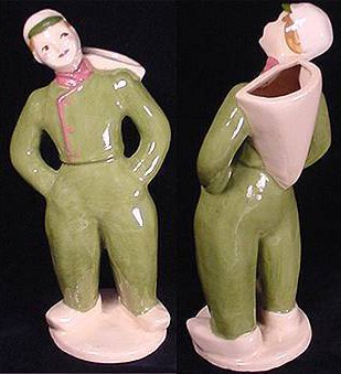 Pink clay pottery boy in green uniform by Hedi Schoop.
