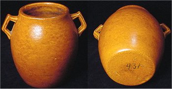 Orange Haeger 431 pot with crystalline glaze, which gives it a dark and light mottled pattern.