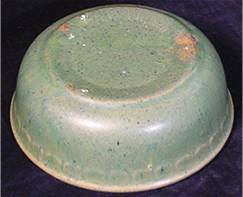Bottom of green McCoy bowl made from yellow clay.