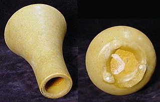 Tan Van Briggle vase with sloppy glaze unevenly dripped over bottom to make the foot.