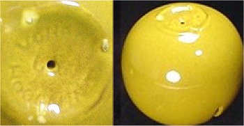 Yellow Vohann marked bowl with clear firing pin bumps on foot.