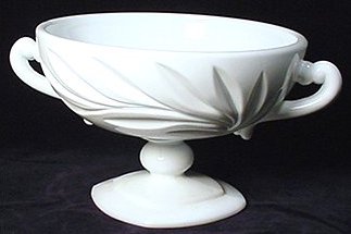 White milk glass cup from Indiana Glass with oleander leaves on the side, also known as the oleander pattern.
