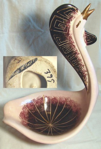 Cream colored swan with red and black highlights and gold beak. Marked "Marc Bellaire, B11-17 HCK 399".