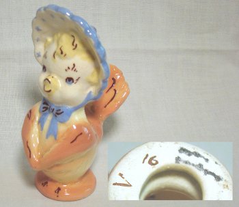 Orange and yellow anthromorphic chick in bonnet singing, marked with the number 16.