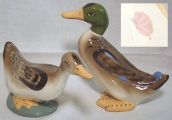 Teal ducks, one with green head named "Honk and Tonk" by Robert Simmons. Marked with paint spot.