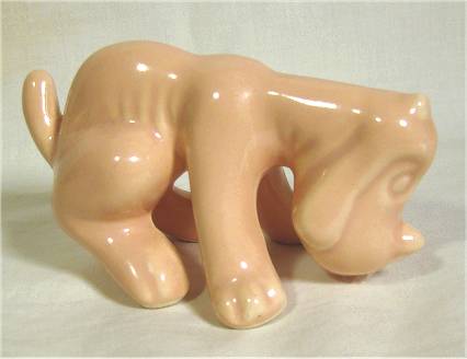 Camark tan "setter" dog figurine sniffing at ground.