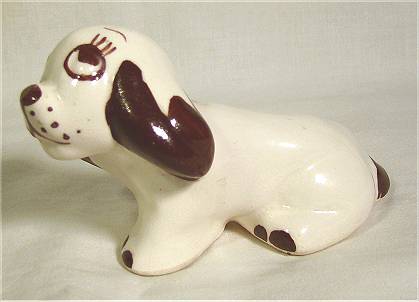 Rio Hondo or Chic Pottery dog sitting, white with brown highlights.
