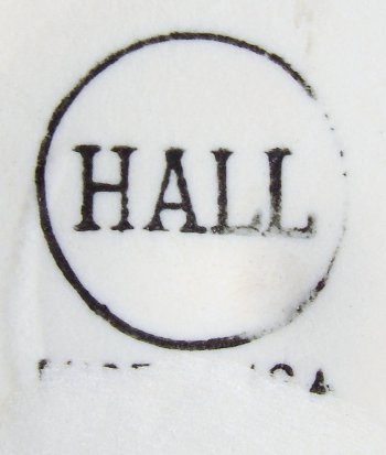 Hall in capital letters in a circle stamped in black ink on vitreous china candle holder.