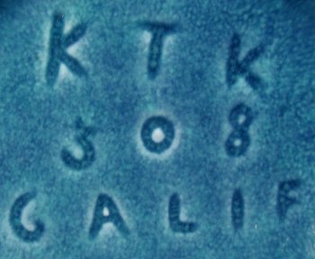 KTK Calif 308 mark on white clay vase with blue glaze.