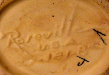 Typical Roseville Pottery yellow clay vase marked Roseville USA with decorator marks in black.